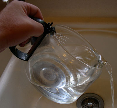 pour warm water with a coffee pot.